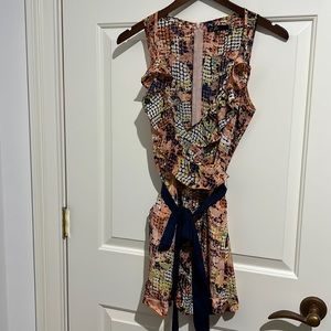 Adorable shorts romper with ruffle detail front and tie belt